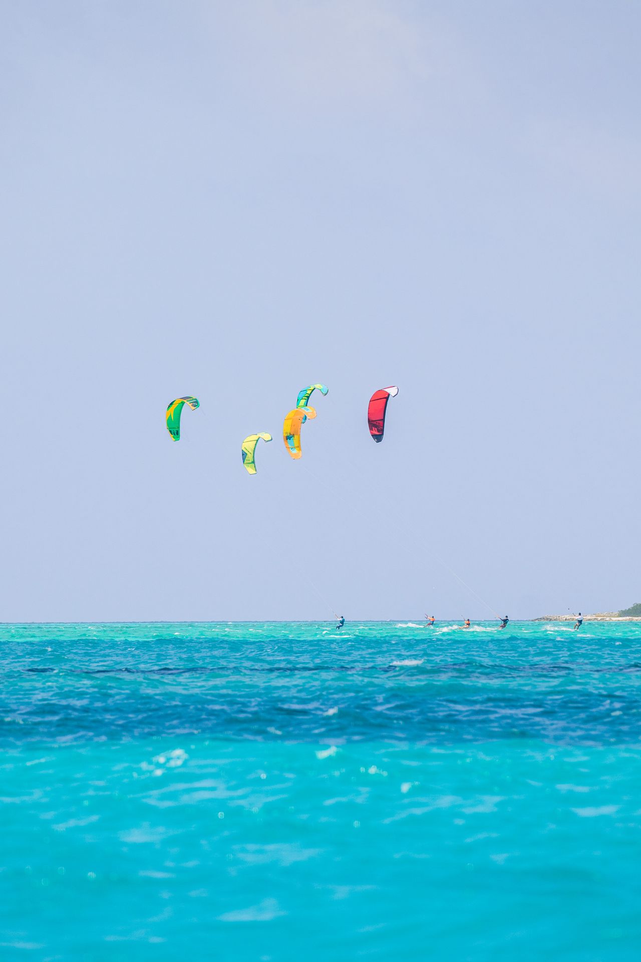 Kitesurfing on Paje beach — colorful kites, turquoise Indian Ocean, windy coastal conditions