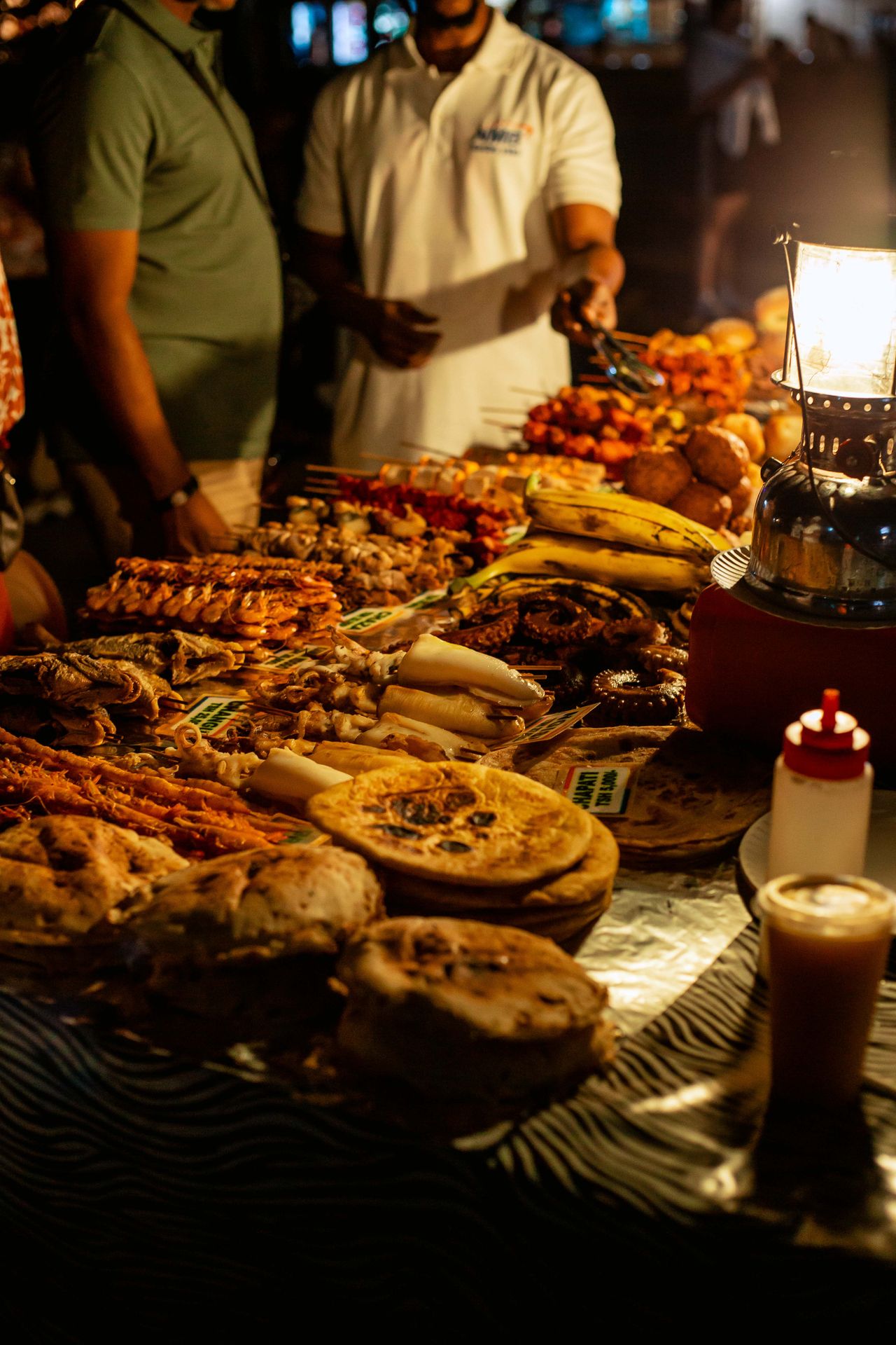 Forodhani Gardens night market — fresh seafood skewers, zanzibar pizza, local street food display