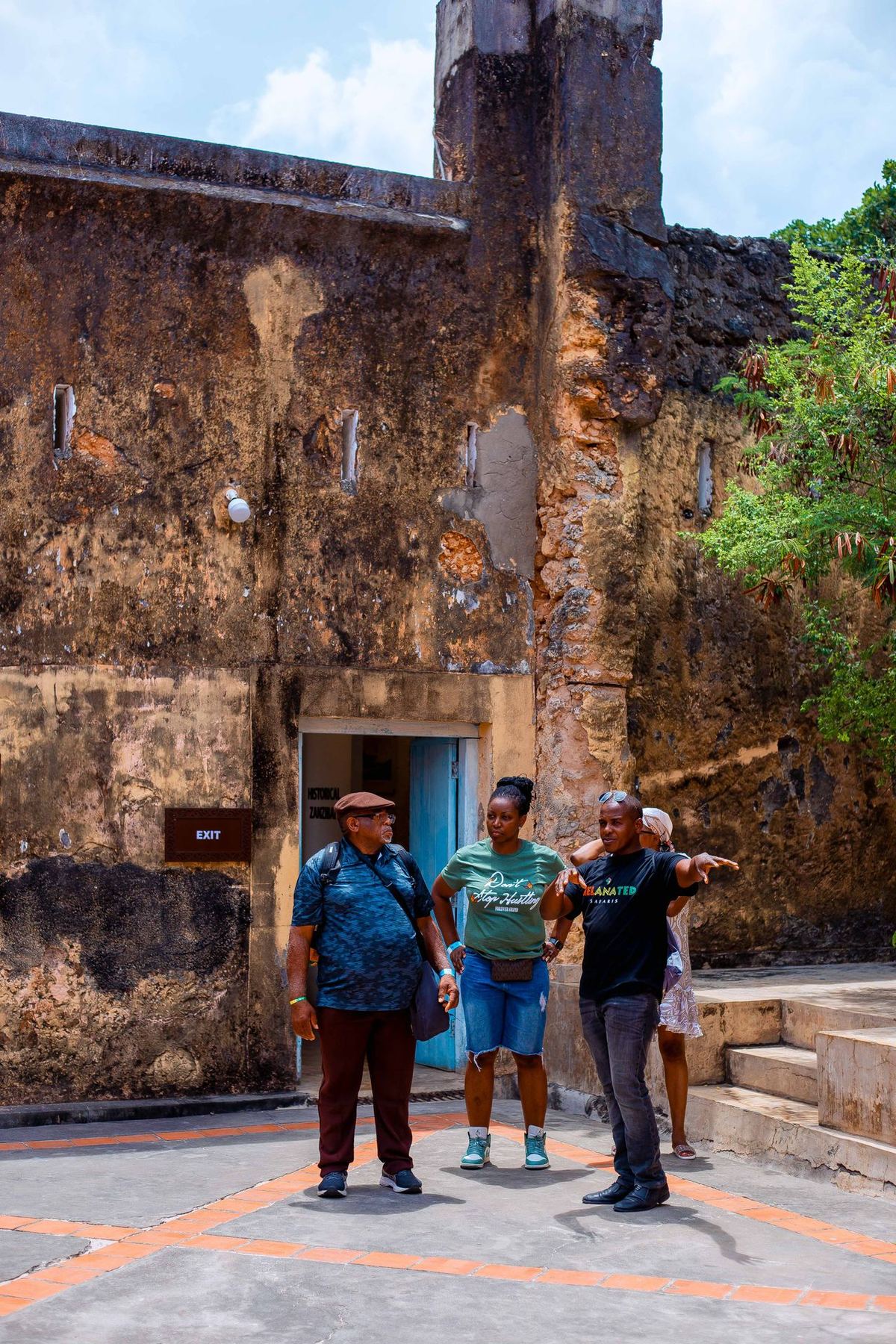 Old Fort in Stone Town — local guide explaining history to tourists inside the ancient stone courtyard