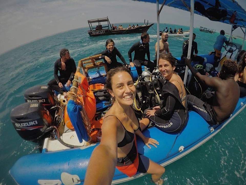 Divers on a boat with scuba gear in the ocean — Zanzibar diving excursion