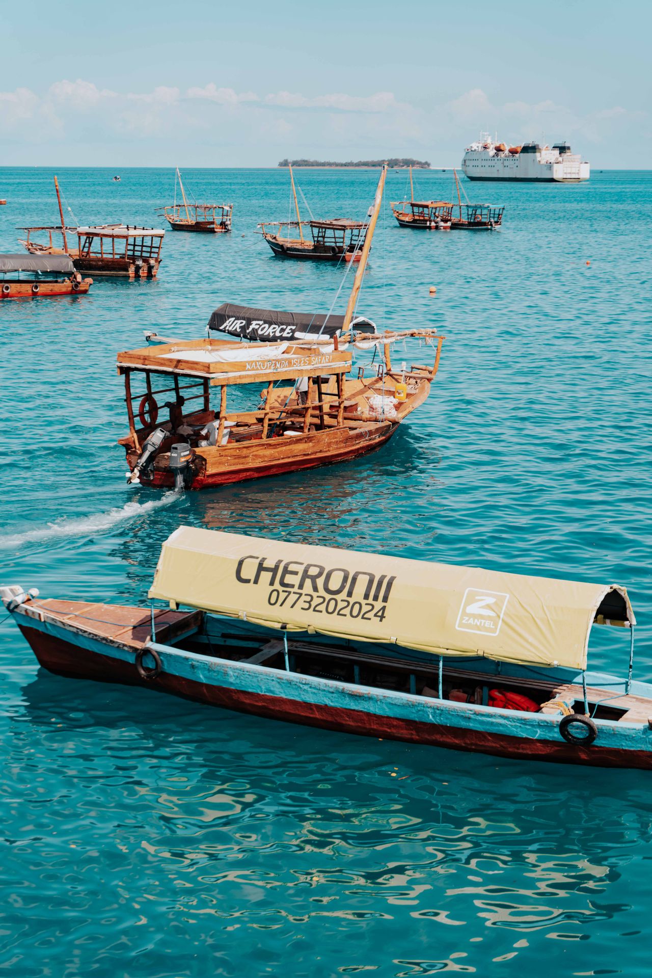 Traditional dhow boats in Stone Town — turquoise water, Nakupenda Isles Safari, wooden vessels, Indian Ocean